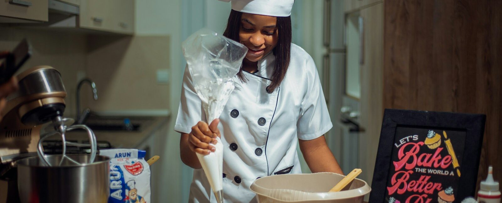 a woman in a chef's outfit preparing food in a kitchen